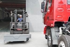 Male factory worker driving forklift truck at crane factory, China